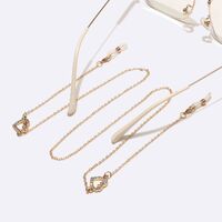 Gold-colored metal non-slip chain, with heart with rhinestone, for glasses and masks GL1457