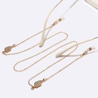 Gold-colored metal non-slip chain, with leaves with rhinestines, for glasses and masks GL1454