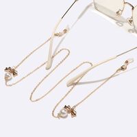 Gold-colored metal non-slip chain, with a bow and pearls, for glasses and masks GL1547