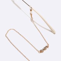 Gold-colored metal non-slip chain, with letters love with rhinestone, for glasses and masks GL1455