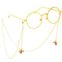 Gold-colored metal non-slip chain, with pendant bee with rhinestone, for glasses and masks GL373
