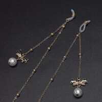 Gold-colored metal non-slip chain, with pendant bow with pearl and beads, for glasses and masks GL573