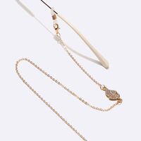 Gold-colored metal non-slip chain, with leaves with rhinestines, for glasses and masks GL1454