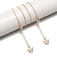 Gold-colored metal non-slip chain, with crown pendant with rhinestones, for glasses and masks GL1510