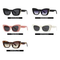 Plastic sunglasses with diamonds in the shape of a 