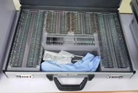 232 metal rim ophthalmic trial lens set in an aluminum case